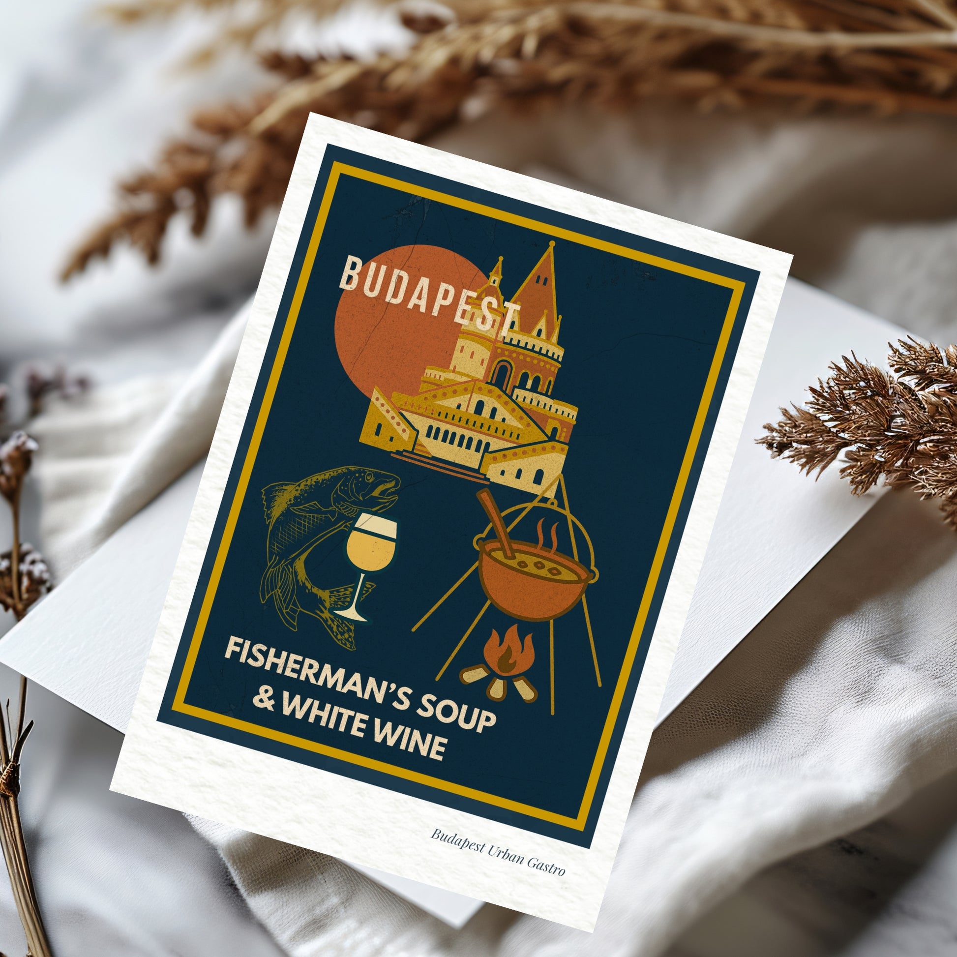 Elegant navy blue Budapest Urban Gastro postcard featuring fisherman’s soup and white wine with Fisherman’s Bastion on a soft neutral fabric background in warm daylight.