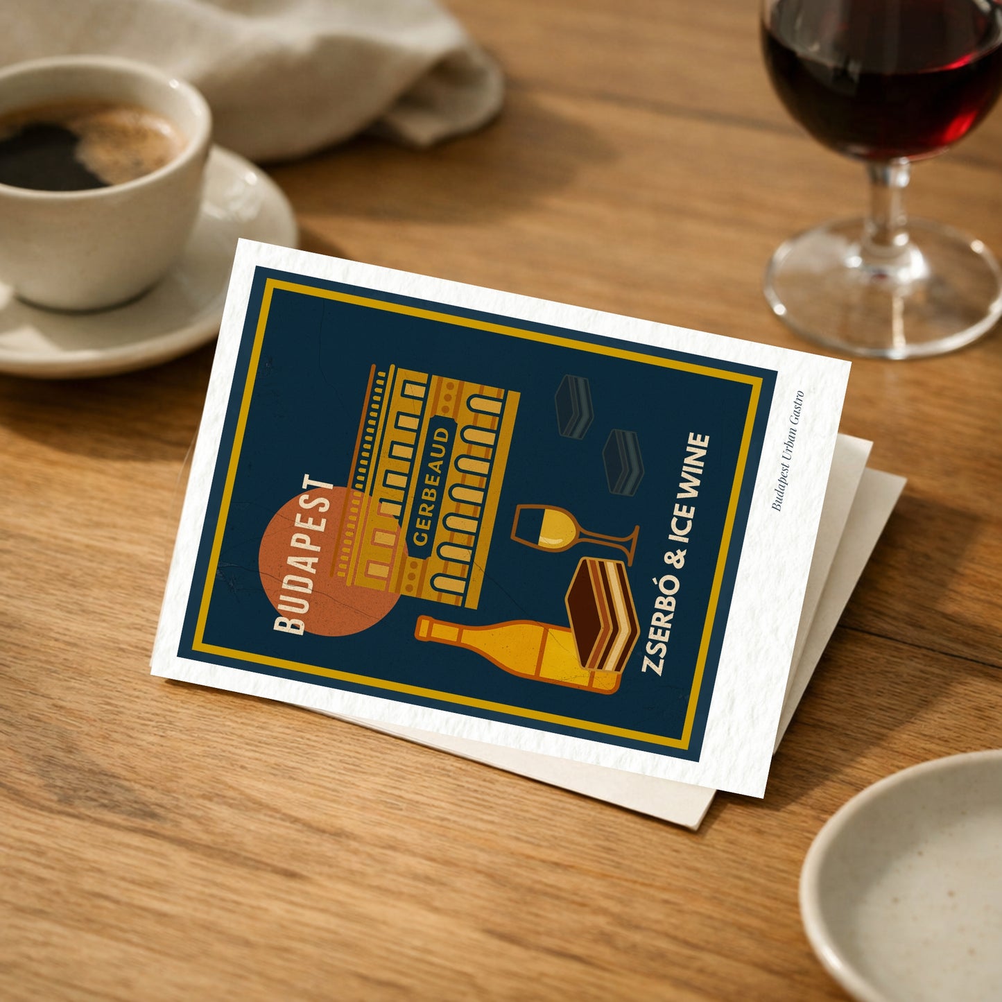 Budapest Zserbó & Ice Wine navy blue art postcard on a wooden café table with espresso and red wine, elegant Budapest Urban Gastro dessert and wine illustration