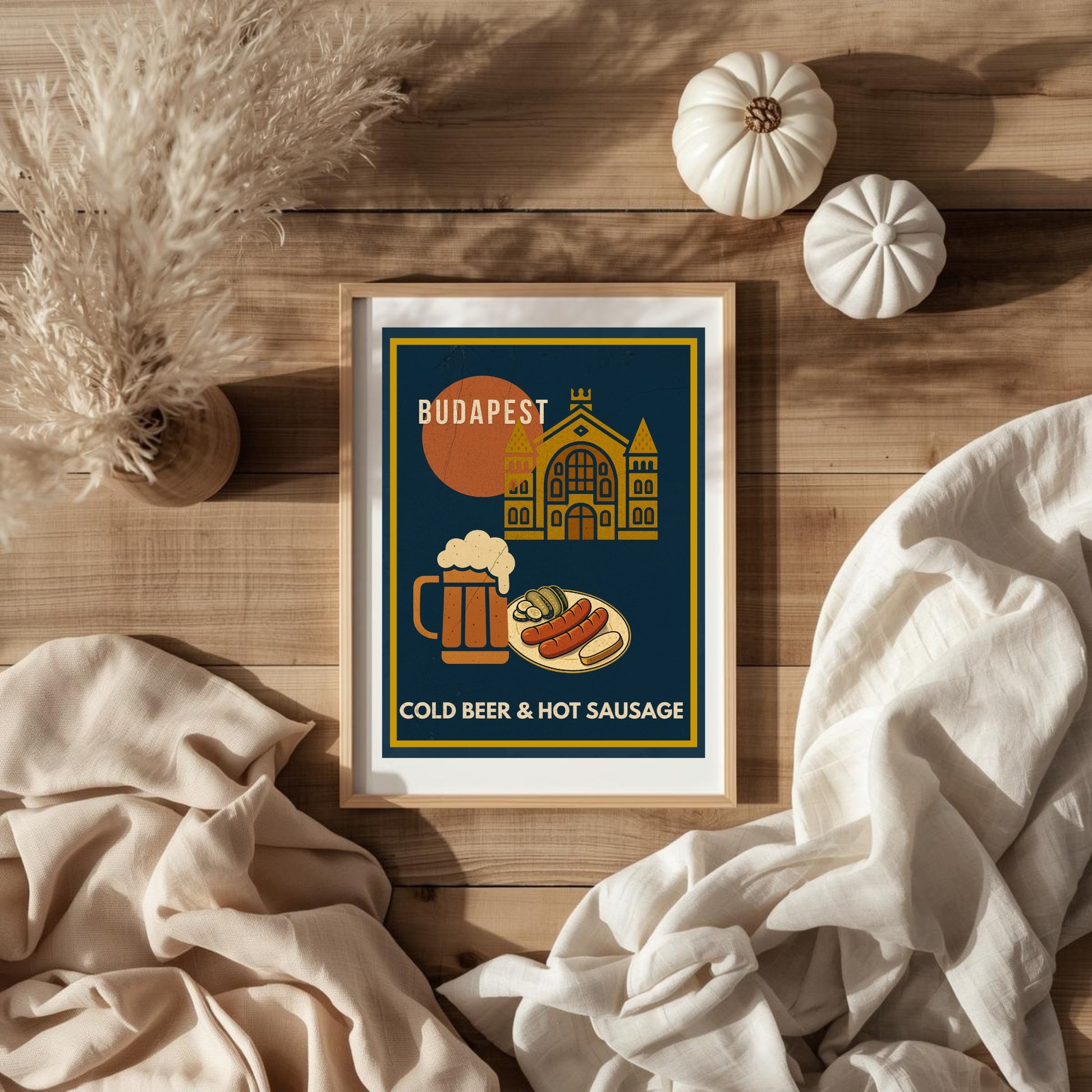 Budapest Urban Gastro poster with cold beer and hot sausage laid flat on a wooden surface with natural textiles and decor, styled as a cozy lifestyle flat lay.