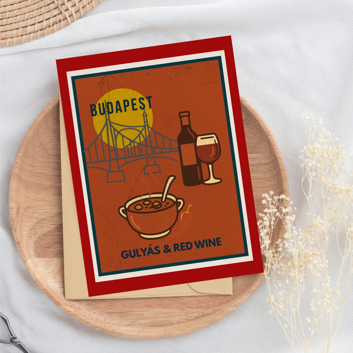 Hungarian goulash and red wine art print photographed as a flat lay on a wooden tray with natural textiles, suggesting a cozy, travel-inspired gift.