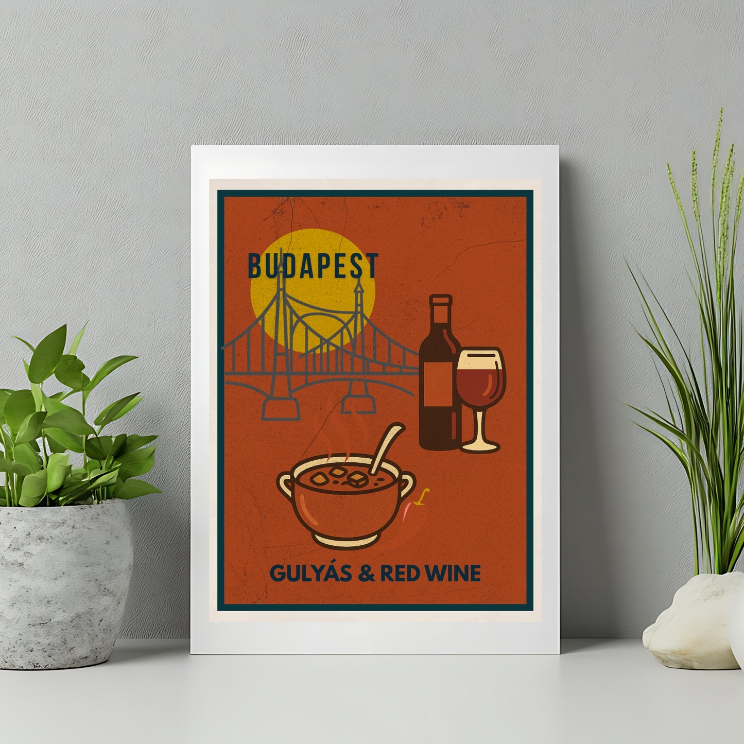Budapest-inspired food art print with goulash and red wine illustration, shown in a minimalist home interior with plants and neutral tones, highlighting modern kitchen wall decor.