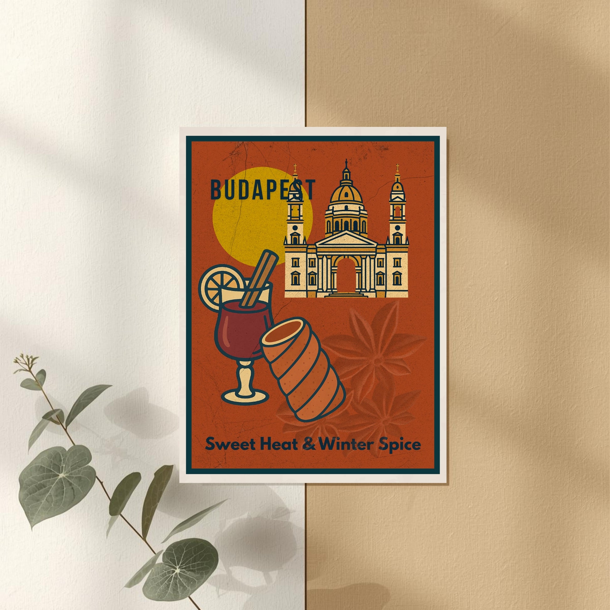 Flat lay mockup of the “Sweet Heat & Winter Spice” Budapest poster on a light wooden table with coffee and minimal decor.